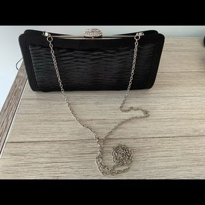 Satin clutch with cubic zirconia clasp.